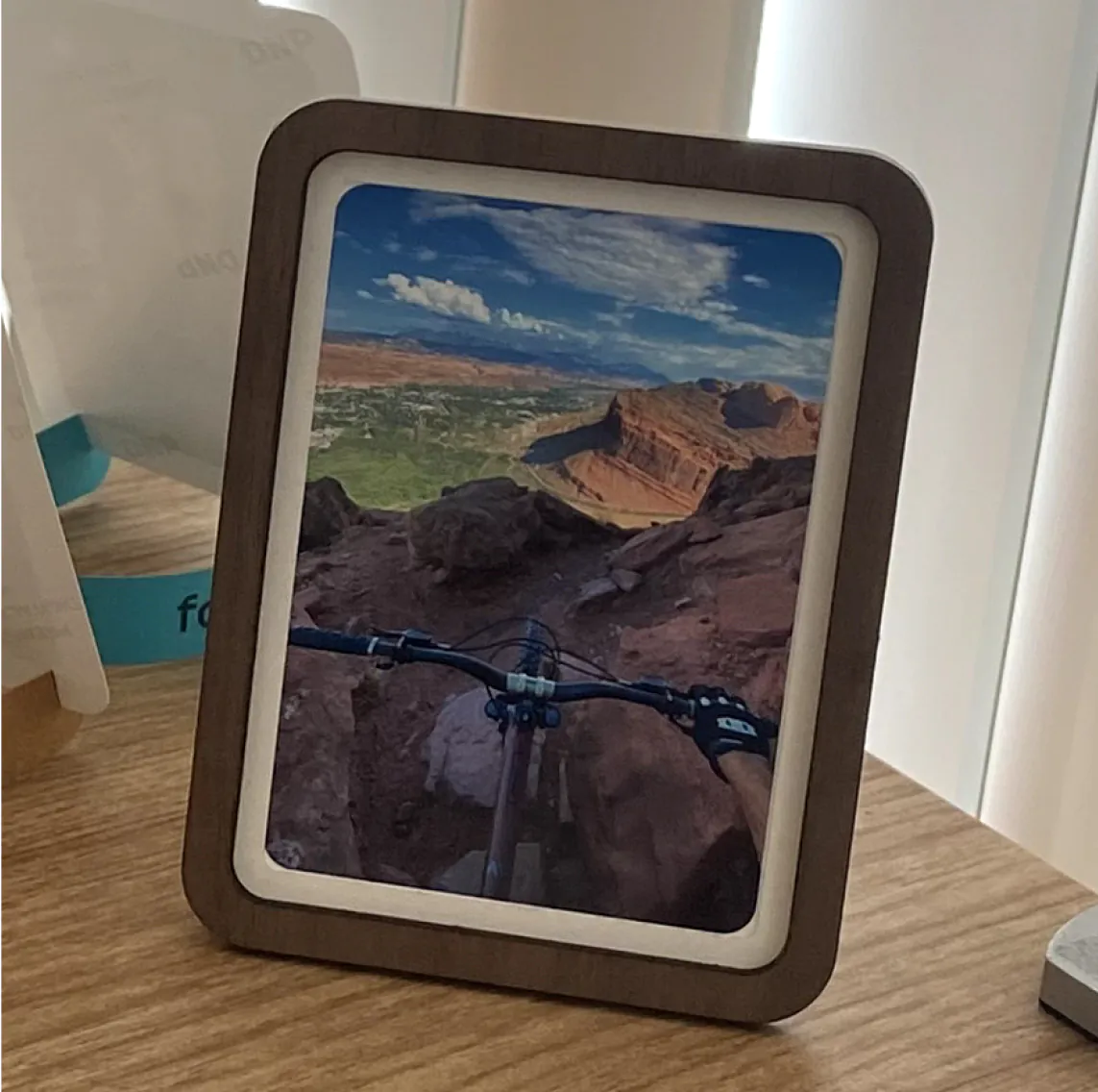 Portrait Pop-up Frame with a mountain-bike photo above red desert canyons