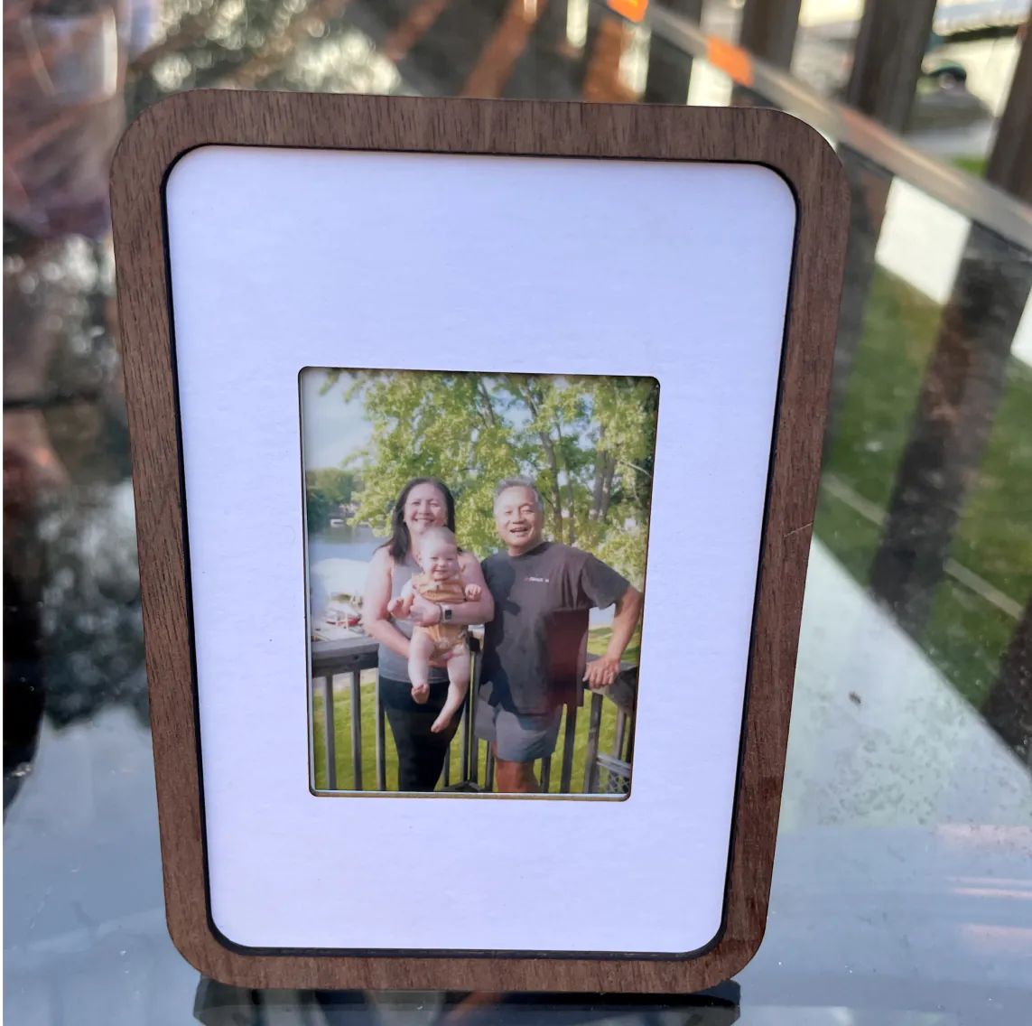 Pop-up Frame holding a family photo on a sunny deck