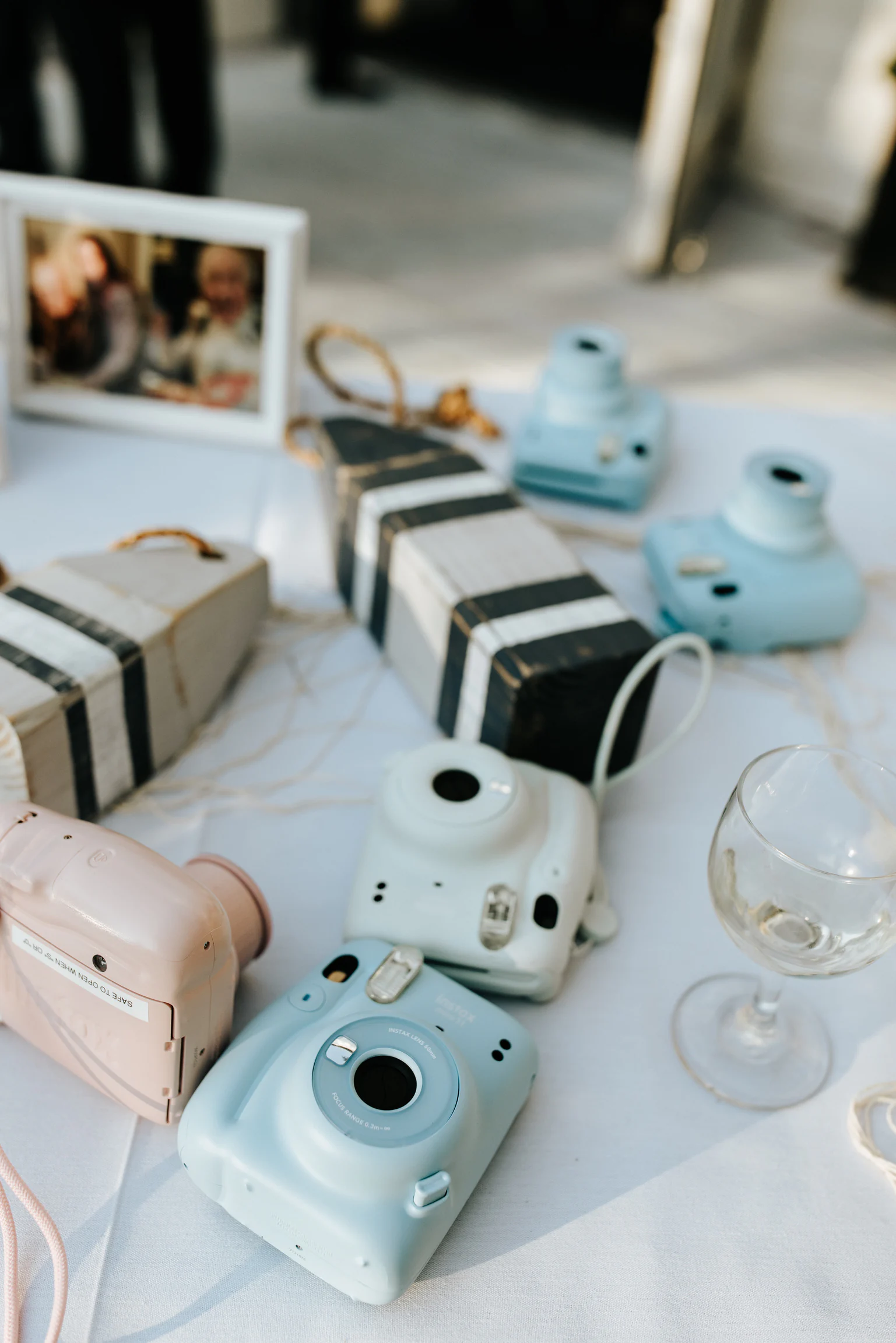 instax mini cameras set out on tables at a wedding reception