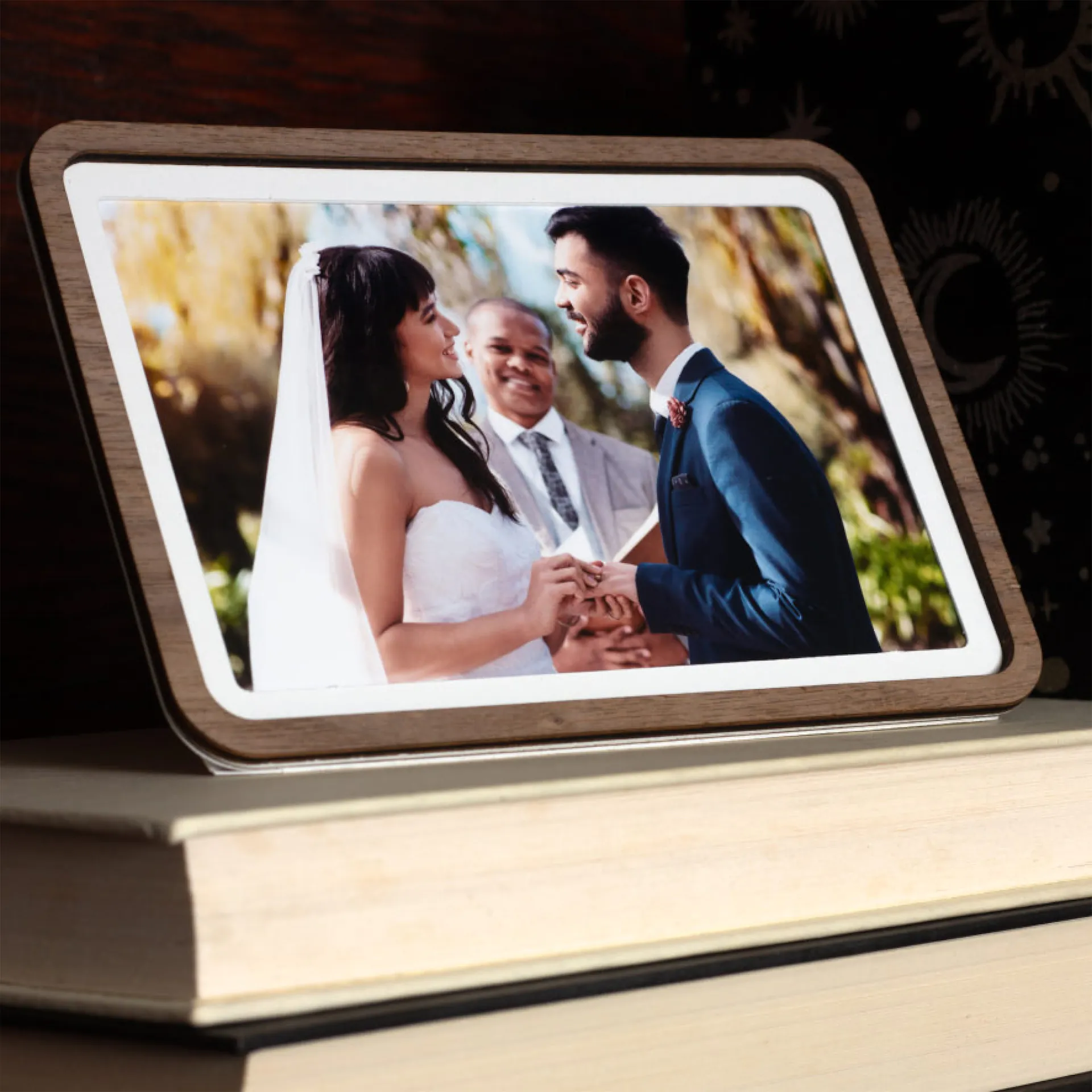 A Pop-up Frame with a wedding photo of a couple, standing on a stack of books